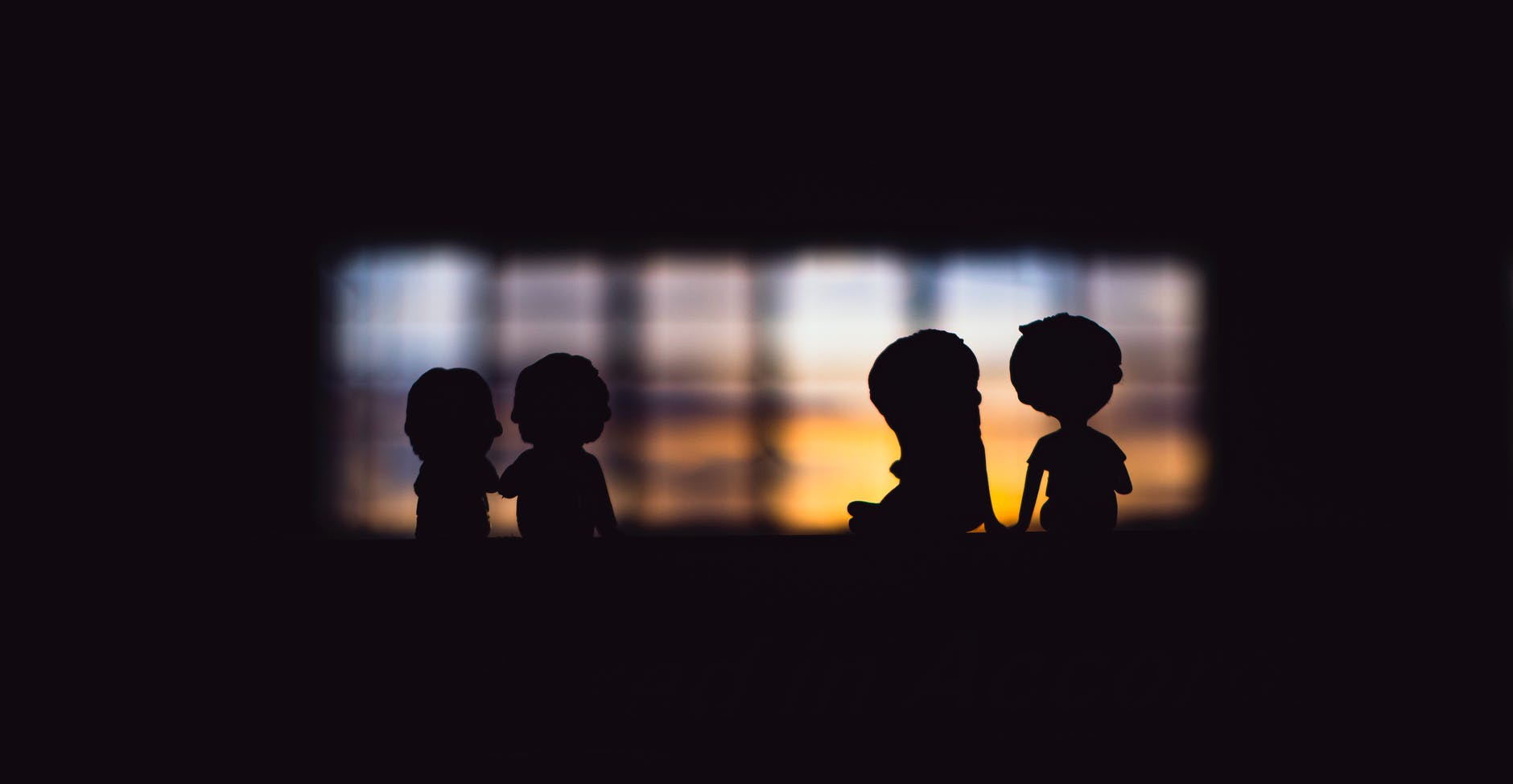 figurine couples in darkness near window