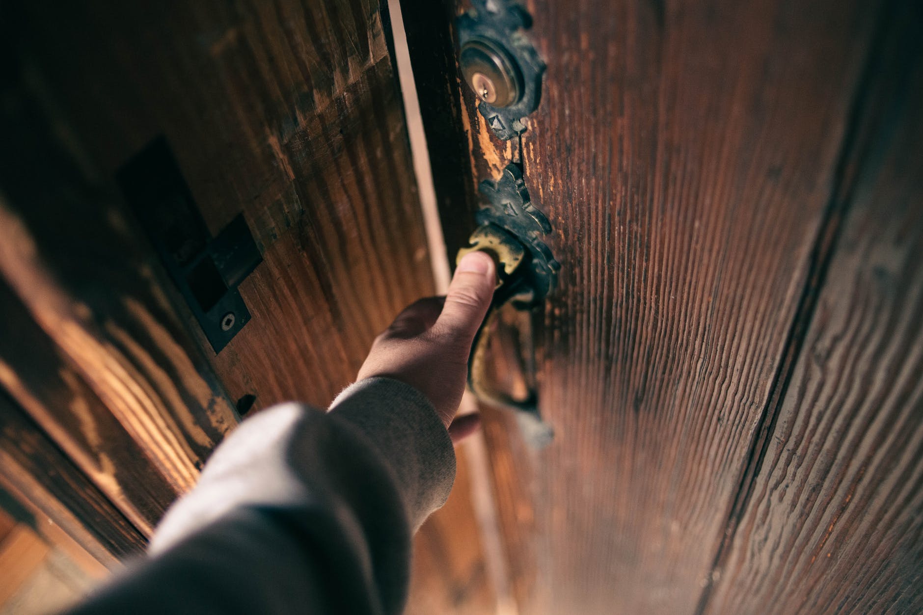 close up on mans hand holding door handle